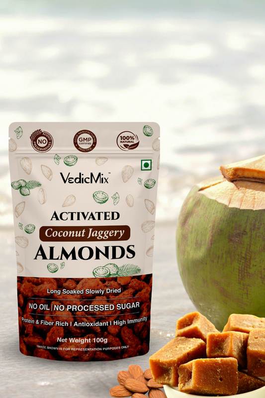 Packaging of VedicMix Activated Coconut Jaggery Almonds with whole almonds, coconut pieces, and syrup displayed in the foreground.