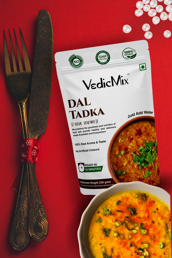 Packaging of VedicMix Dal Tadka with a picture of the prepared dish and a fork on the side, against a red background.